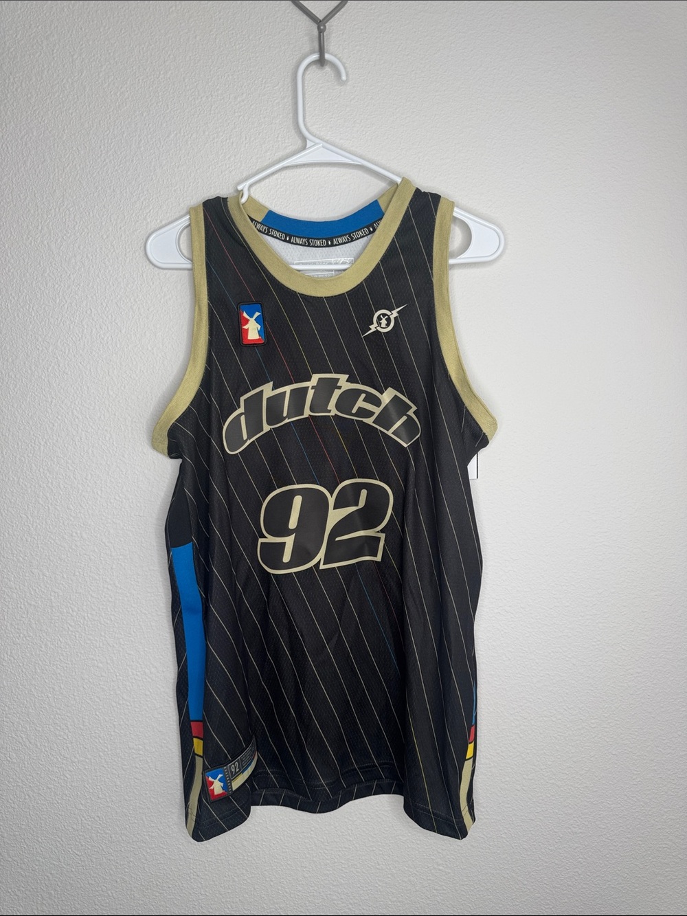 Dutch Bros Black Pinstripe Basketball Jersey with Gold Trim and Blue Accents